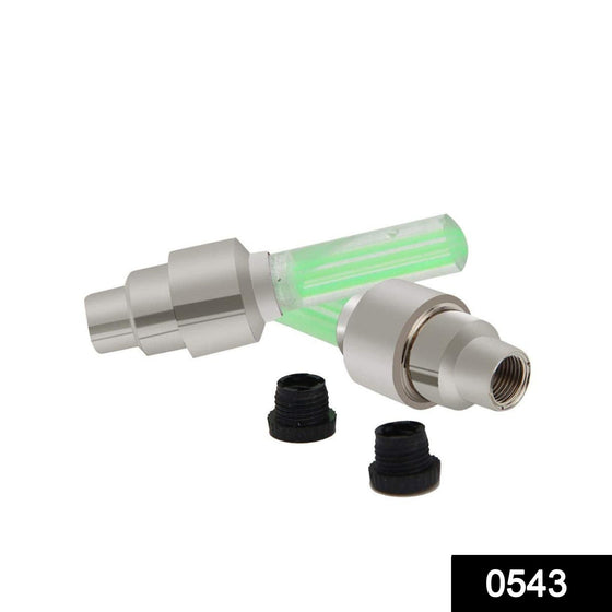 Two silver and green illuminated valve cap lights with two black plastic caps on a white background.