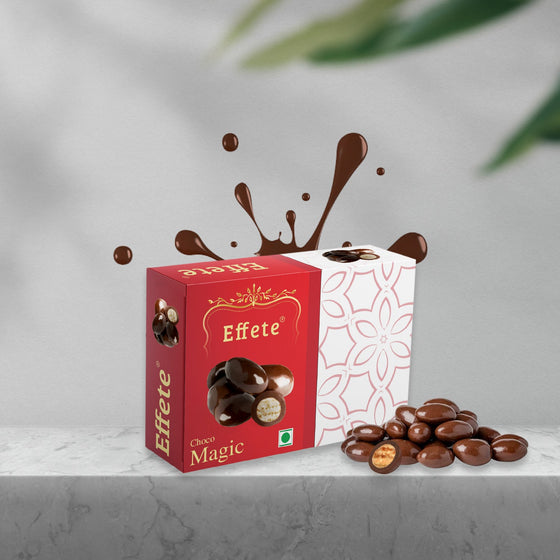 Red and white box of Effete Choco Magic with chocolate-covered wafer bites spilling out, against a grey background.