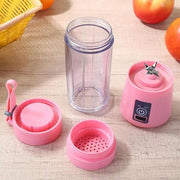 Hand holding the compact portable USB juicer, demonstrating its size