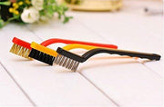 Three small cleaning brushes with colorful handles and different bristle types on a white wooden surface.
