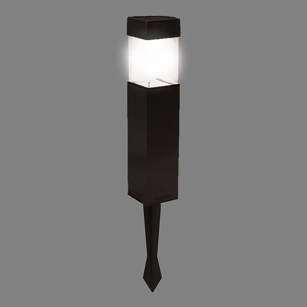 Bright solar light glowing in a dark garden setting