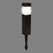 Bright solar light glowing in a dark garden setting