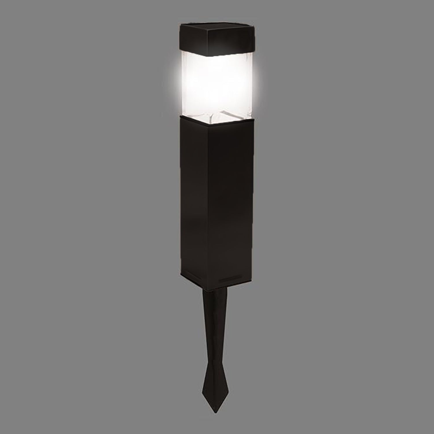 Bright solar light glowing in a dark garden setting