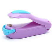 A purple and blue heat sealer is shown open, revealing its heating element and compact design.