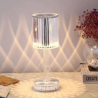 Crystal LED table lamp glowing with warm light on a wooden surface