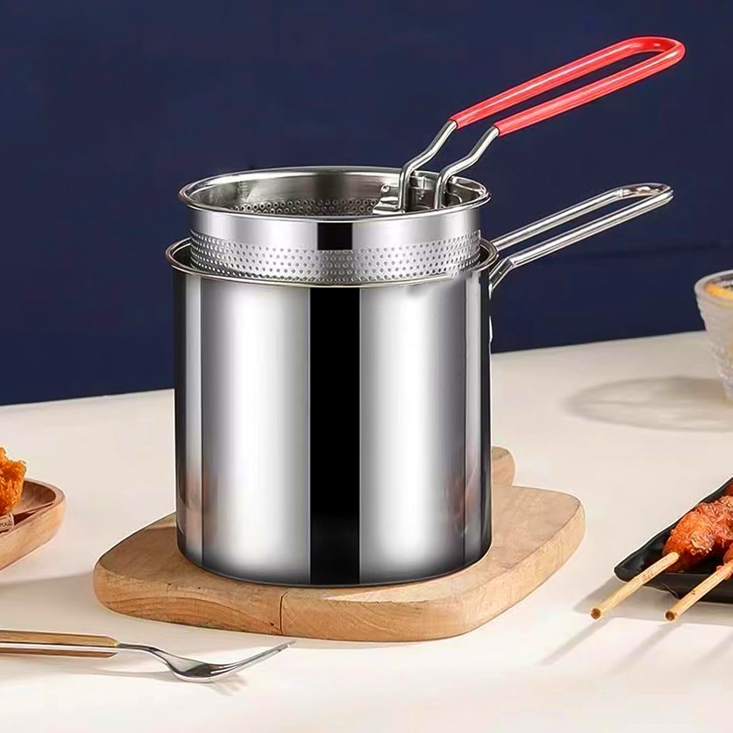 Deep frying pot and strainer basket showing long handle