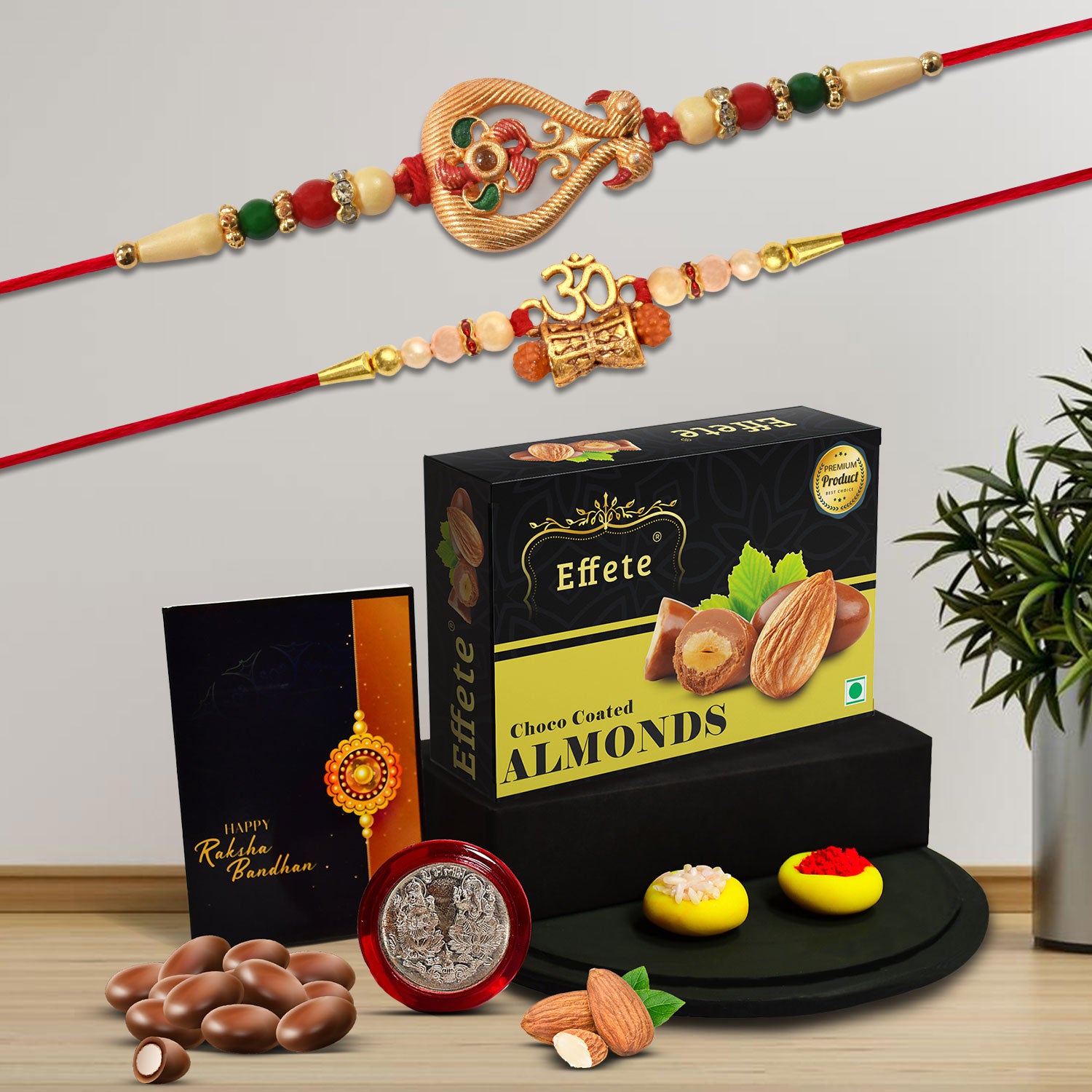 Beautiful Rakhi Combo Box with fancy Rakhis, choco almond treats, and a pooja coin.