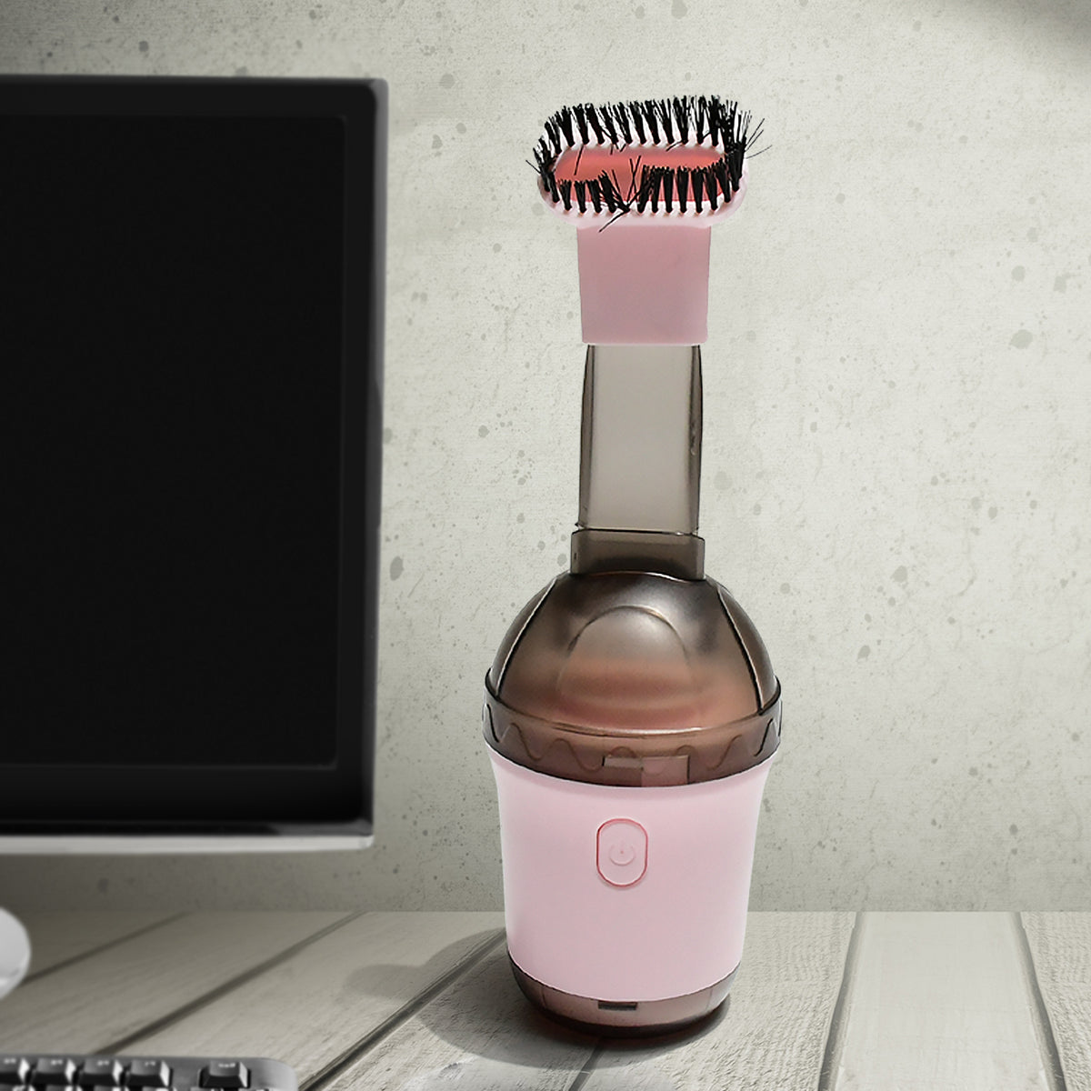Person using mini vacuum to clean a computer keyboard