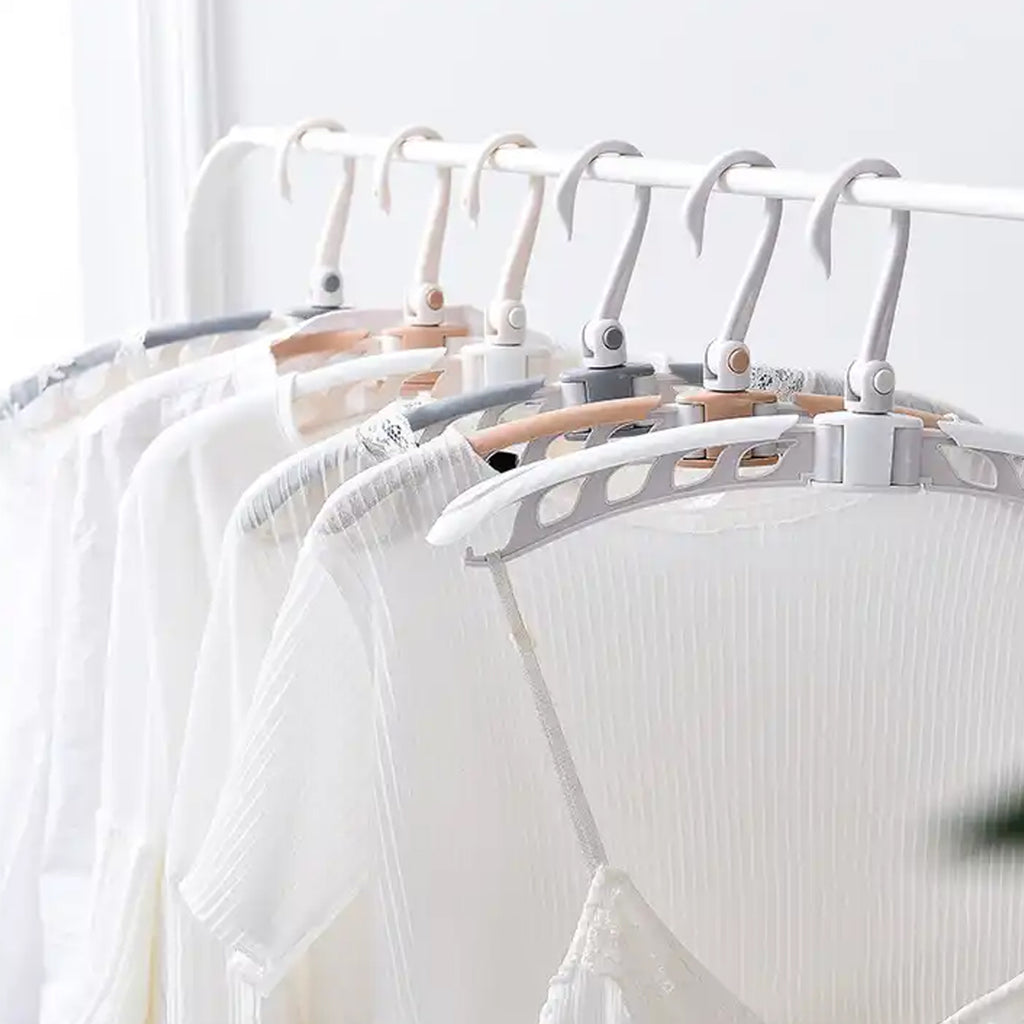 Travel clothes hanger with clothes, demonstrating adjustable arms
