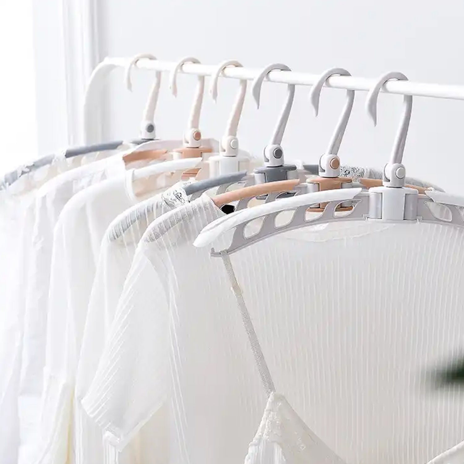 Travel clothes hanger with clothes, demonstrating adjustable arms