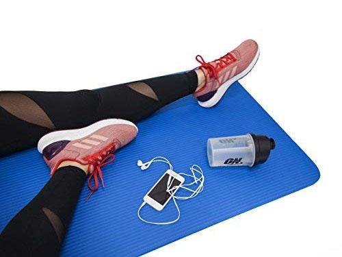 Yoga mat laid out in a clean studio setting, ready for a workout session.