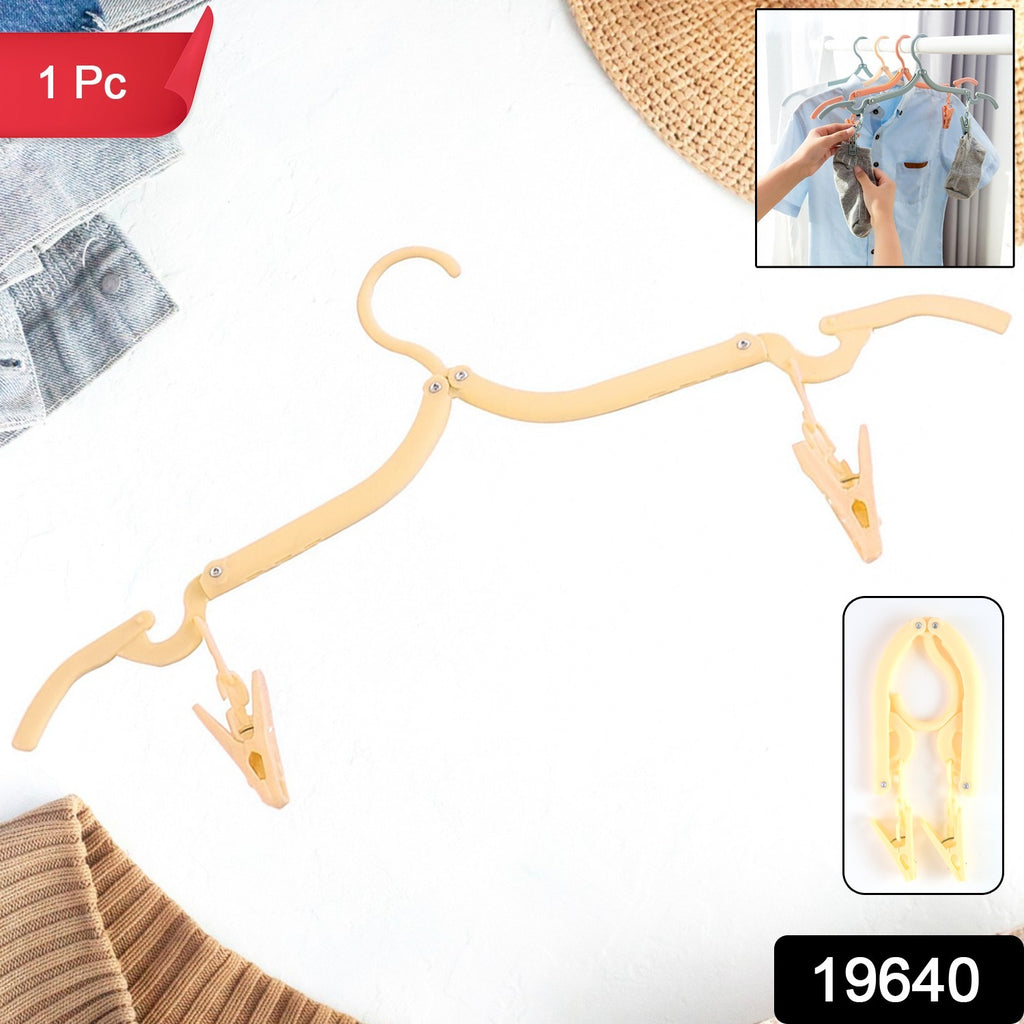 Adjustable folding hanger fully extended, holding clothes
