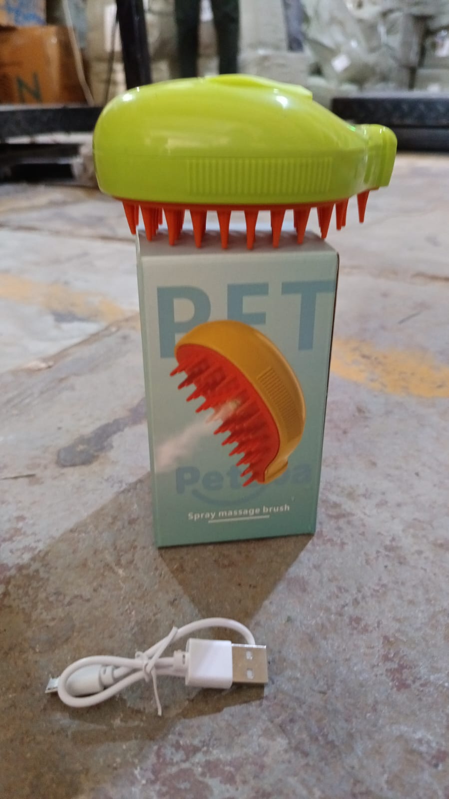 Steam cat grooming brush with ergonomic handle and bristles