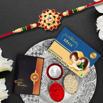Thoughtfully curated Rakhi Gift Box showcasing Rakhi, roli-chawal, coin, greeting card, and chocolate.
