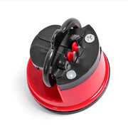 Top-down view of the red and black knife sharpener with a black suction cup base.