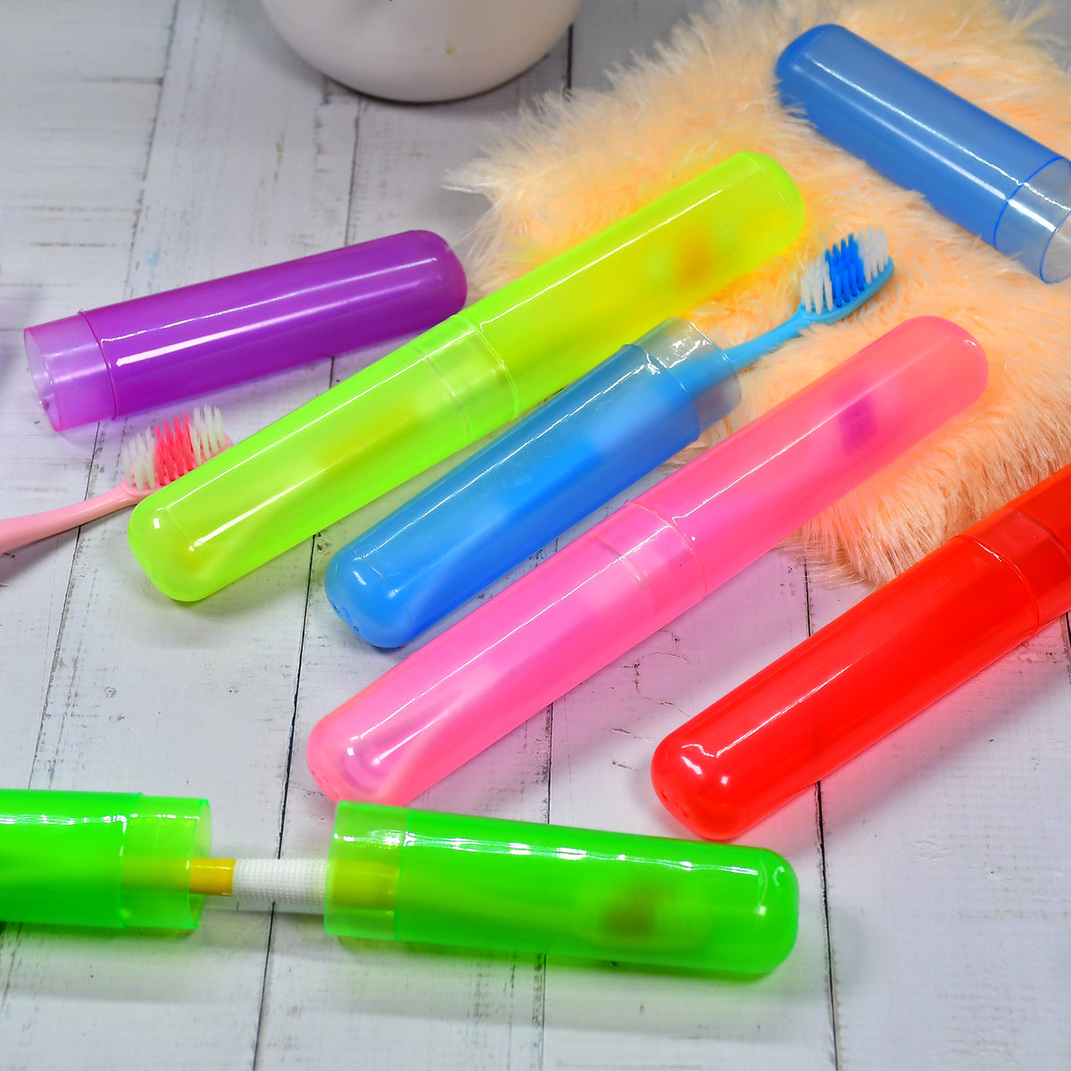 Hand holding a single compact plastic toothbrush cover