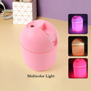 Portable USB humidifier on a desk next to a laptop, ideal for office