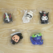 Five different cartoon character charger cover sets, each individually packaged in clear plastic bags on a wooden surface.