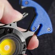 User holding LED keychain flashlight outdoors at night