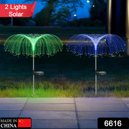 Pair of solar jellyfish garden lights glowing with changing colors at dusk