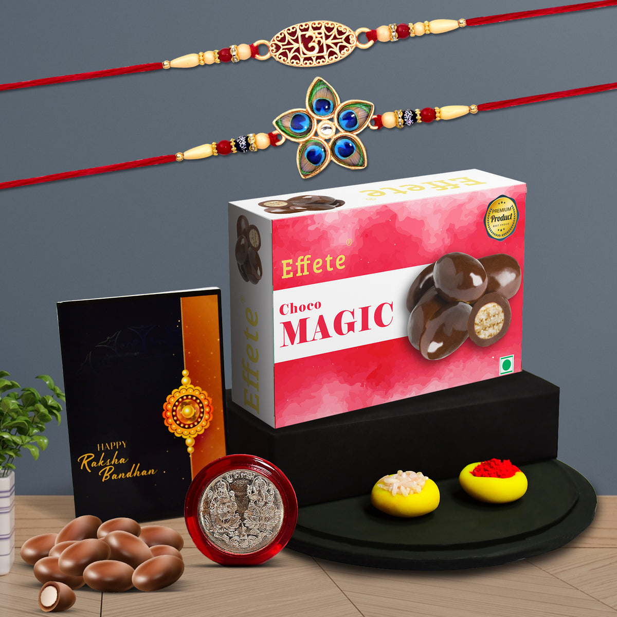 A vibrant Rakhi Gift Hamper featuring a fancy Rakhi, chocolates, greeting card, and silver-colour coin.