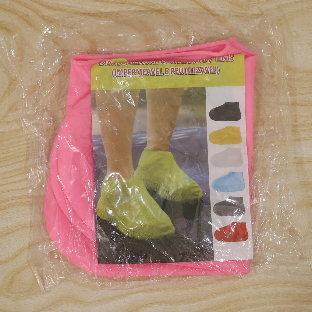 A packaged pair of pink silicone shoe covers is visible through clear plastic, with a label showing people wearing various
