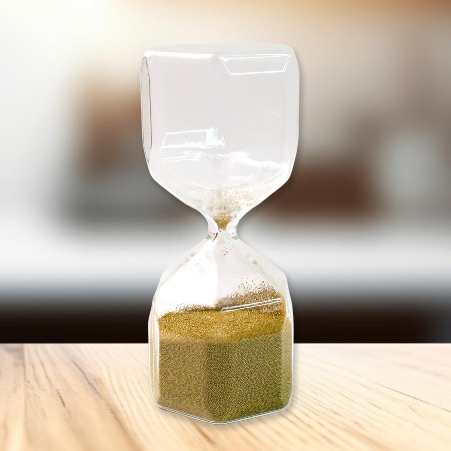 Faceted glass hourglass decorative sand timer in ambient light