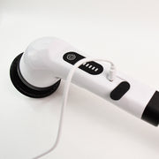 Close-up of the white electric scrubber handle with a charging cable plugged into the side port.