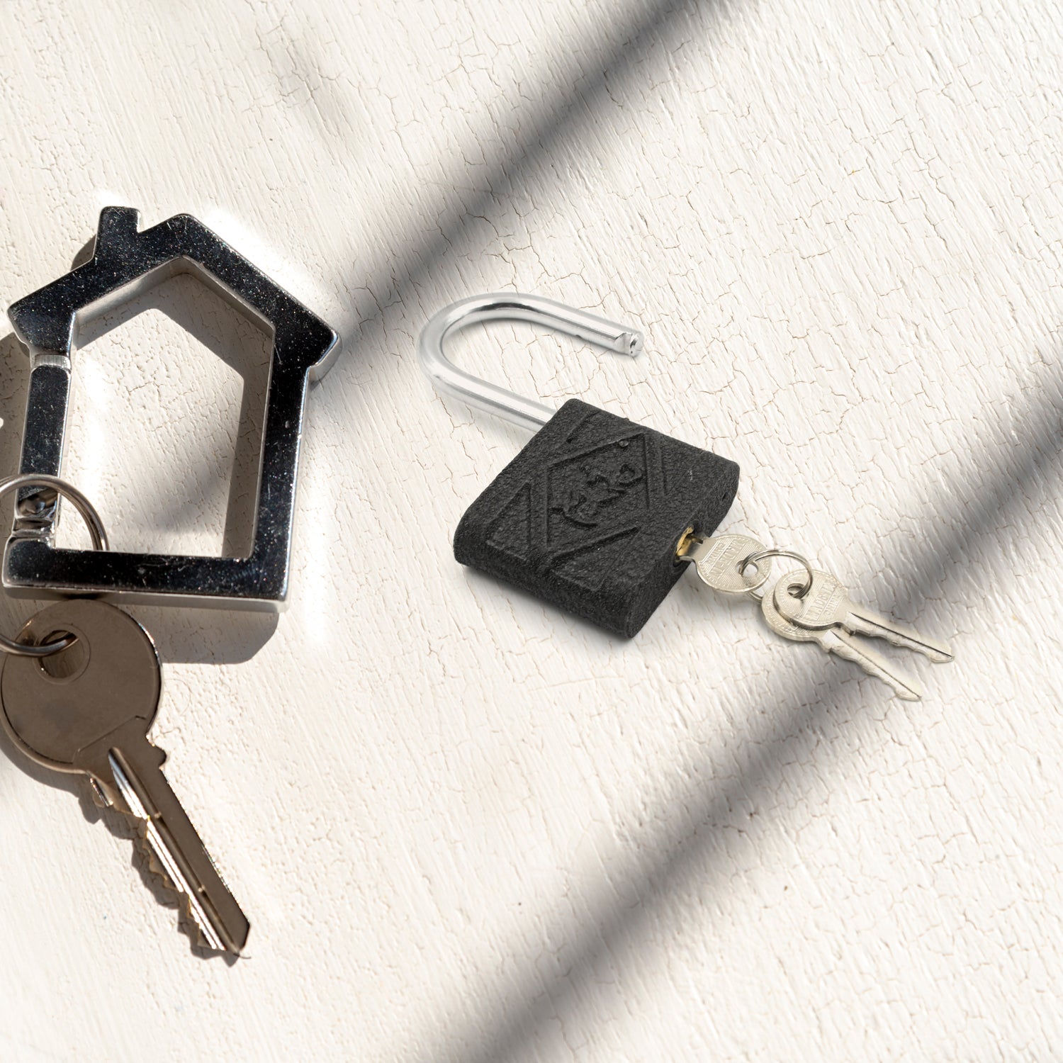 Three views of the 75mm iron padlock, highlighting its robust design