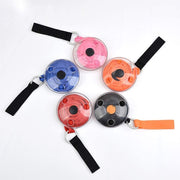 Five circular, clear plastic cases, each containing a different colored shopping bag (pink, blue, orange, red, black), are