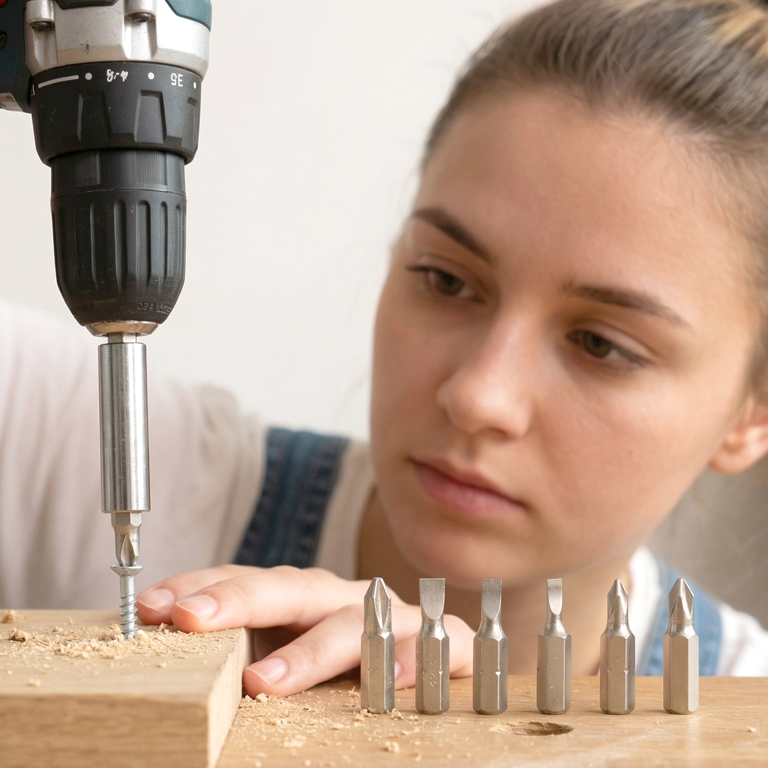 Mini precision screwdriver set on workbench with tools