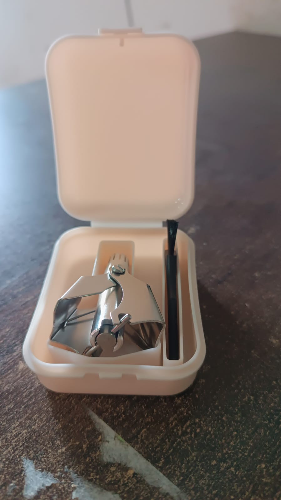 Nose hair clipper with brush and case on white background