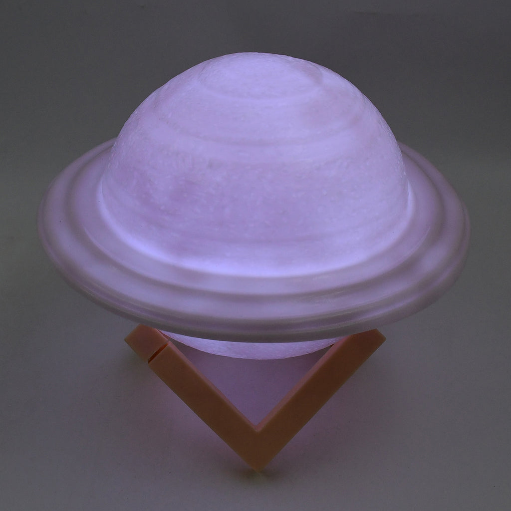 3D Saturn Lamp on a bedside table with soft glow