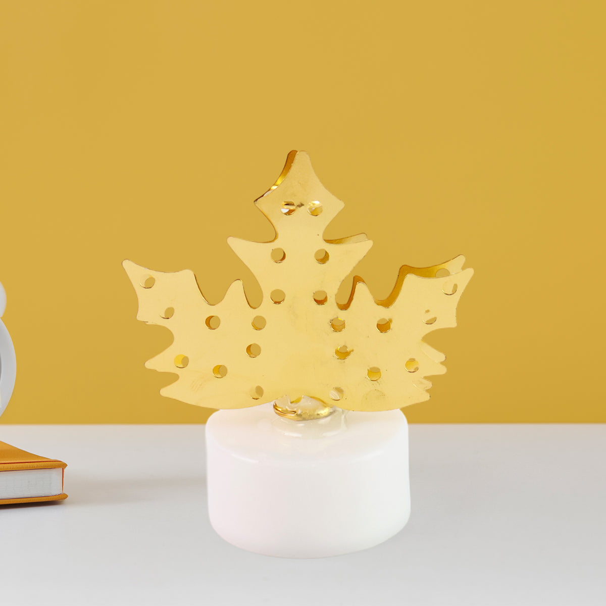 LED gold metal leaf diya lamp displayed on traditional surface