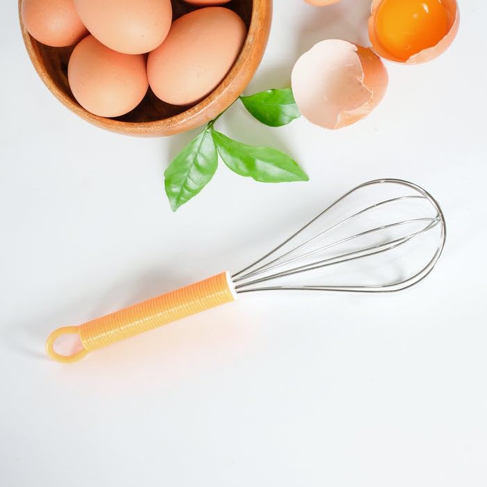 Detailed view of the handles and materials of the stainless steel and silicone kitchen tools.