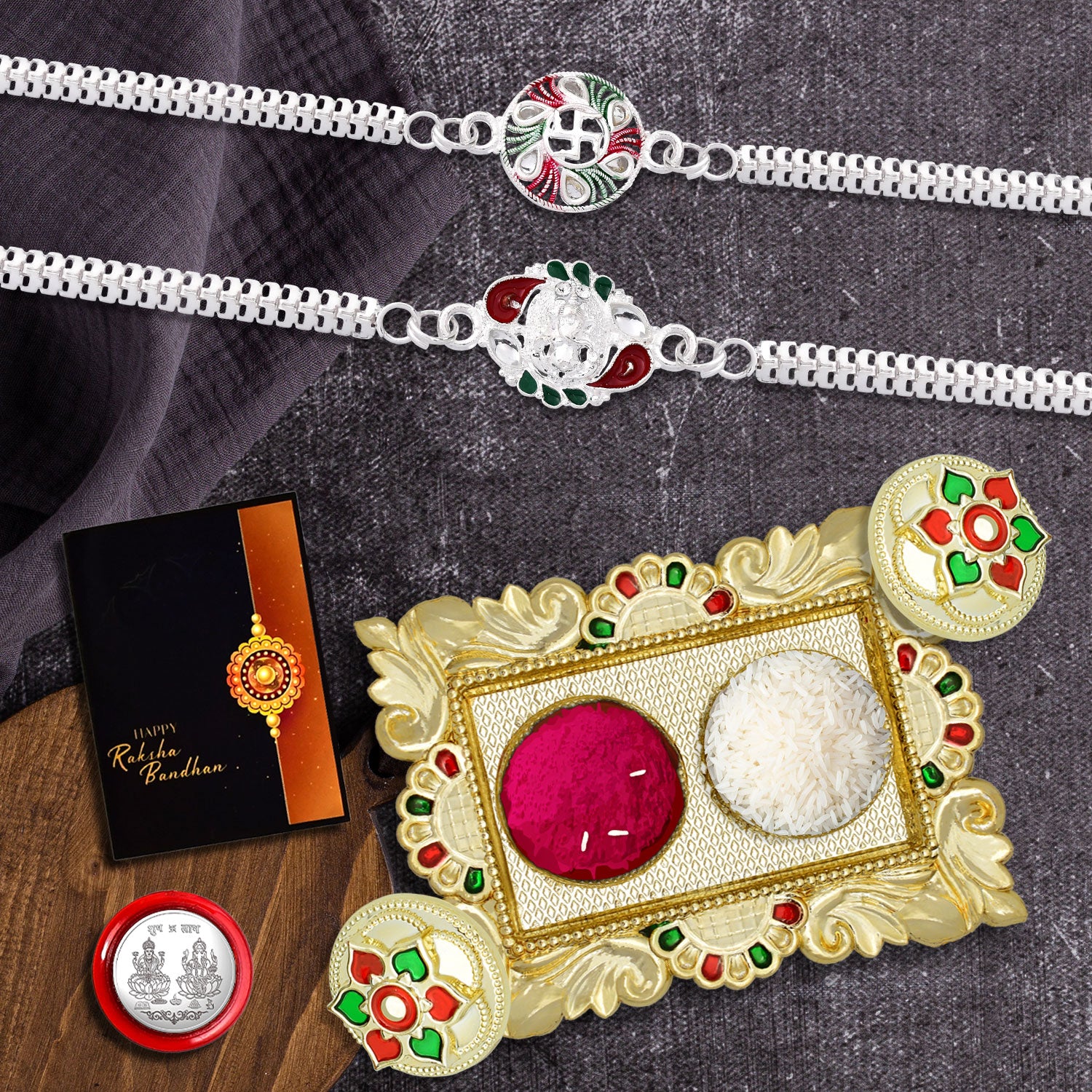 A beautifully arranged Rakhi Set with a red rakhi, roli-chawal, coin, greeting card, and chocolate.