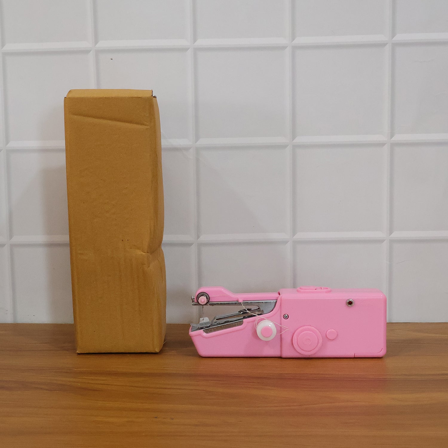 Woman's hand demonstrating use of the mini sewing tool