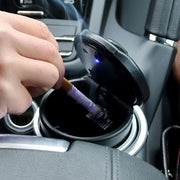 Portable car ashtray with open lid & blue LED light in a vehicle cup holder