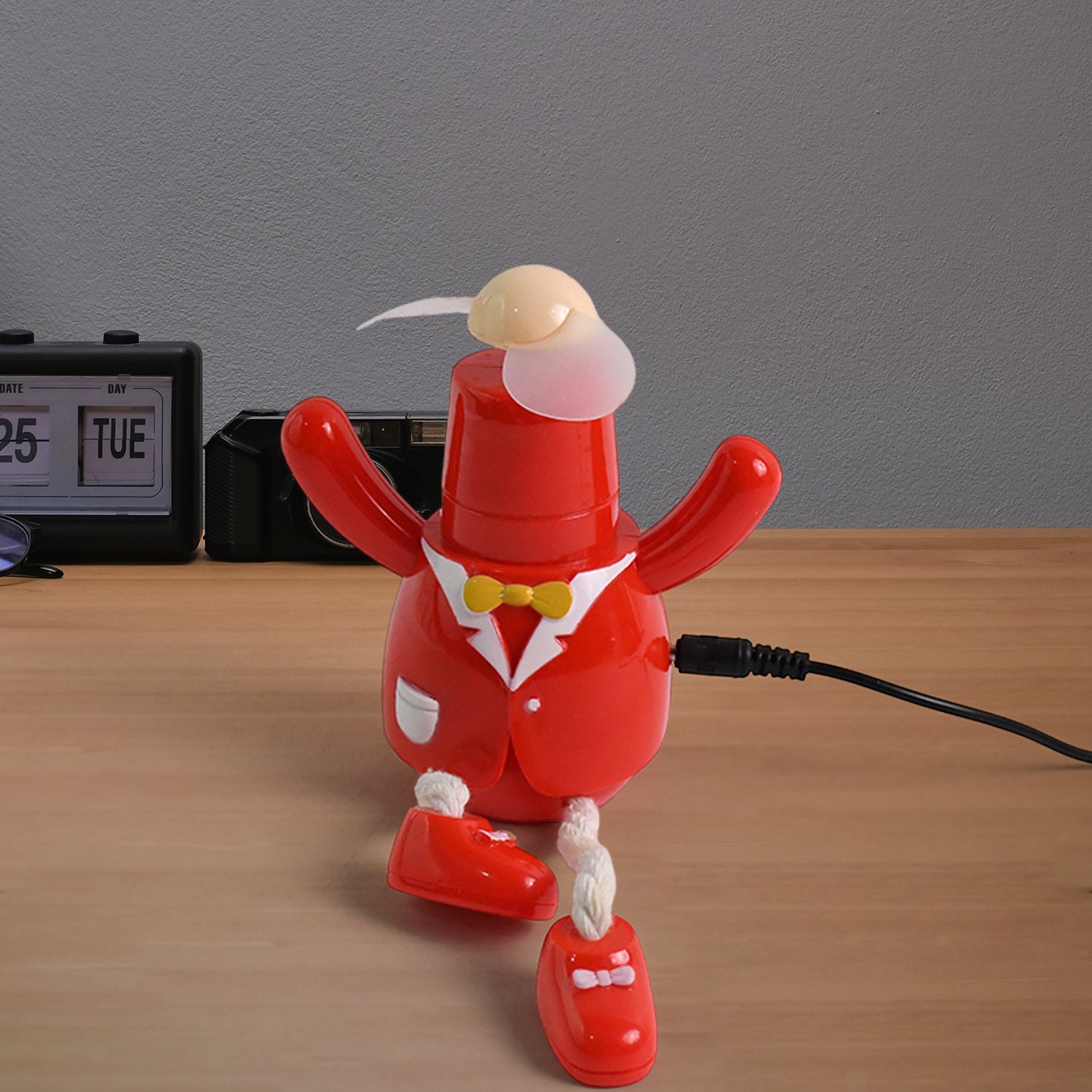 Portable USB powered fan for children connected to a laptop for easy use.