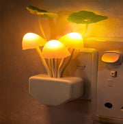 Mushroom night light glowing with colorful light in a dark room