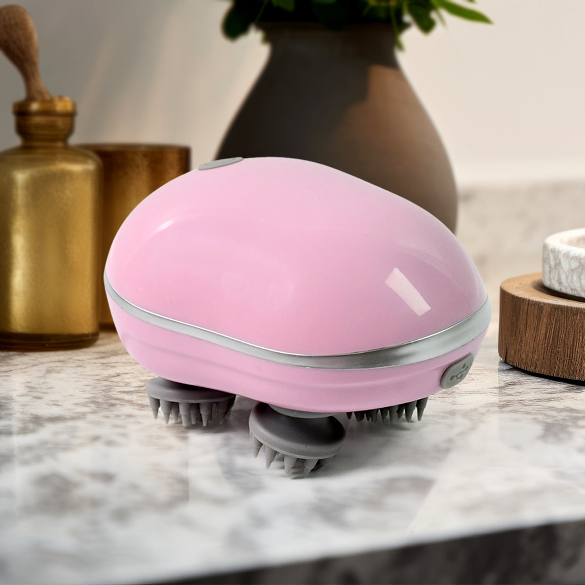 Handheld scalp massager showing ergonomic grip and USB charging port