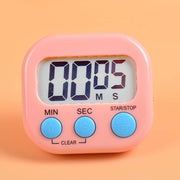 White digital kitchen timer on a counter, ready for cooking