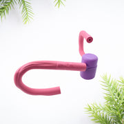 Pink and purple thigh exerciser with green foliage on a white background.