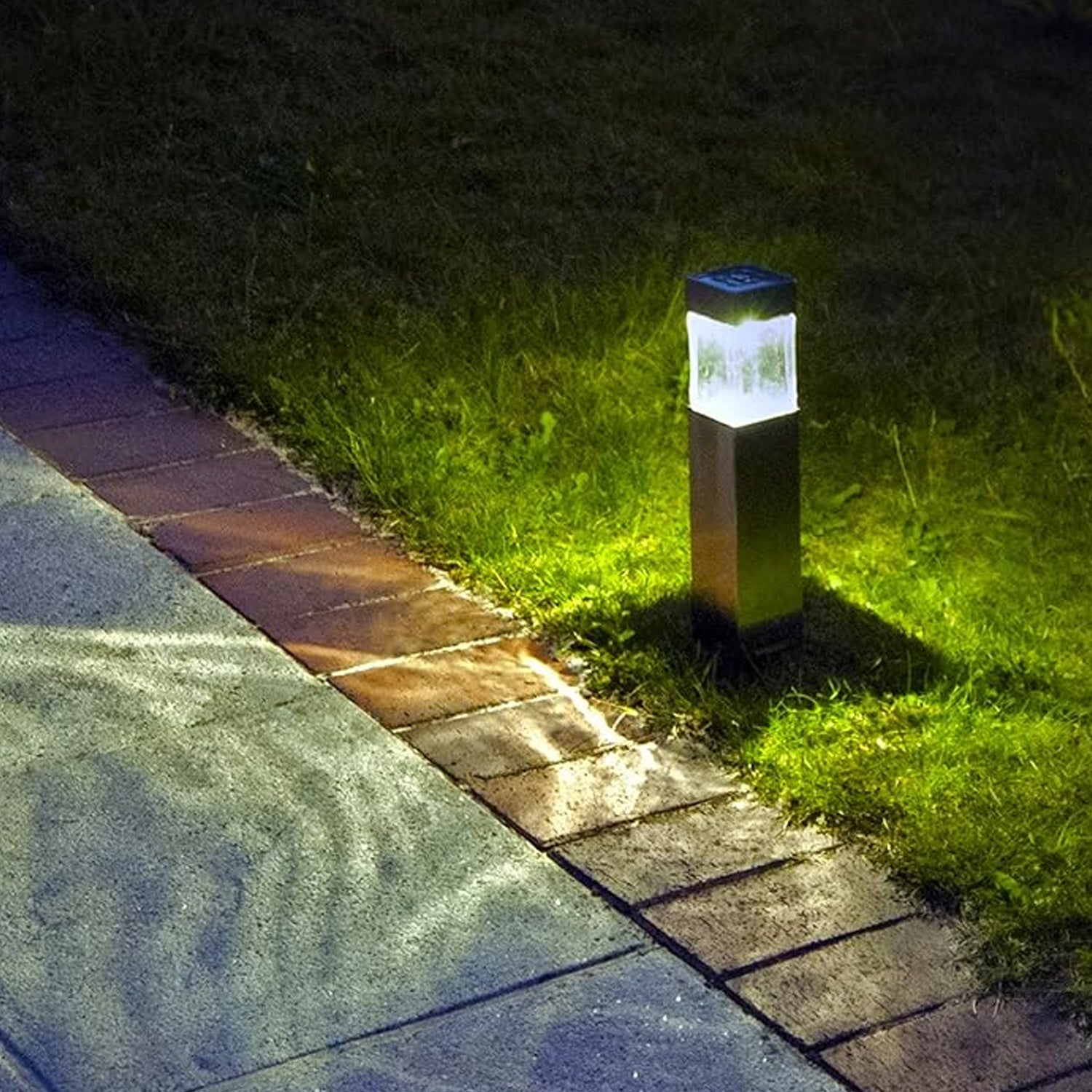 Solar LED light glowing softly in a park at dusk