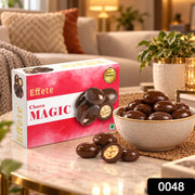 A box of chocolates and a full bowl of them sit on a table in a cozy living room setting.