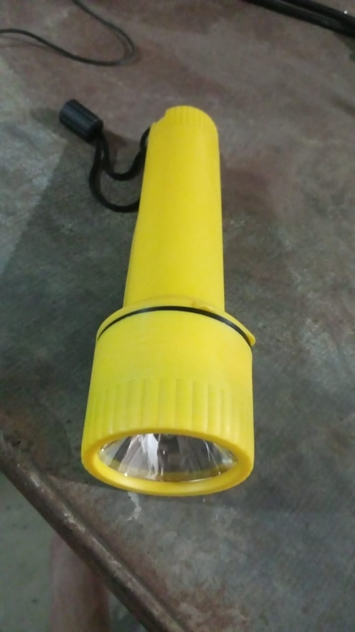 LED flashlight torch casting light in an outdoor setting