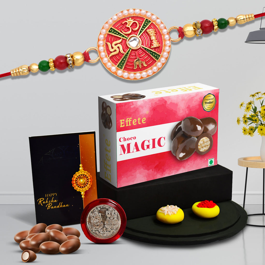 Premium Rakhi Gift Hamper featuring a fancy Rakhi, chocolates, silver coin, and greeting card.