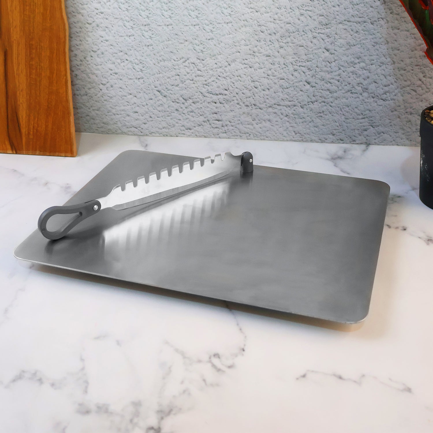 Stainless steel slicer next to various freshly sliced vegetables like cucumber & radish