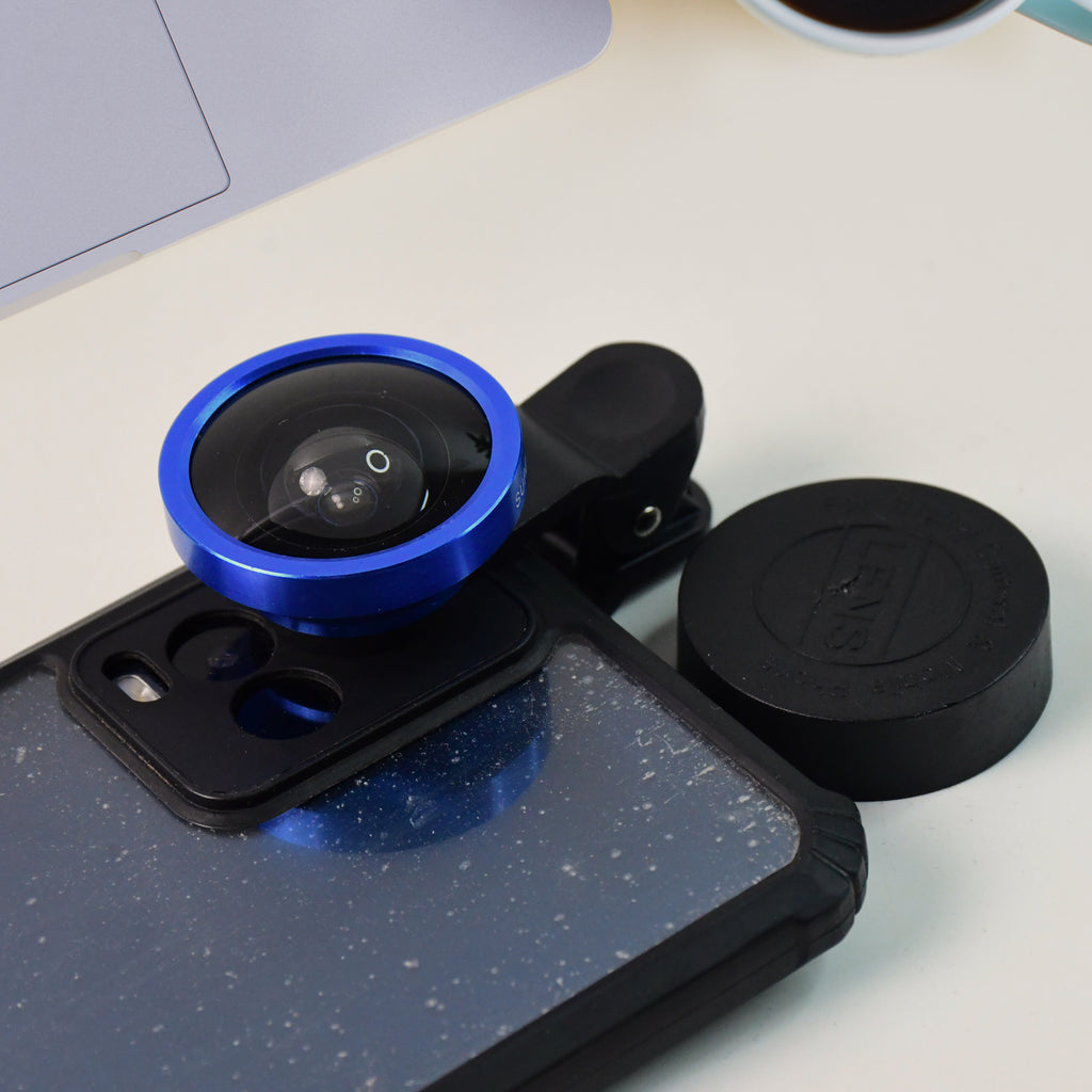 Person using the clip-on wide-angle lens on a smartphone to take a group selfie