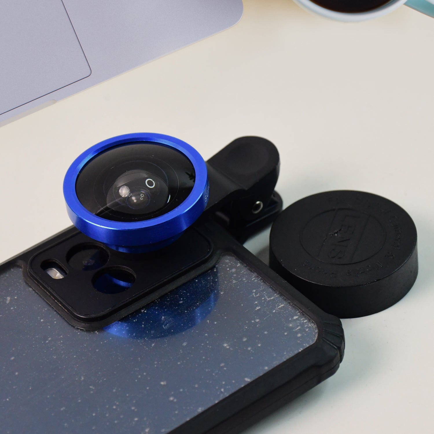 Person using the clip-on wide-angle lens on a smartphone to take a group selfie
